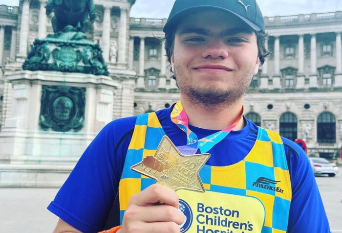 Christiano Iannacone holds his medal from running the Vienna Marathon