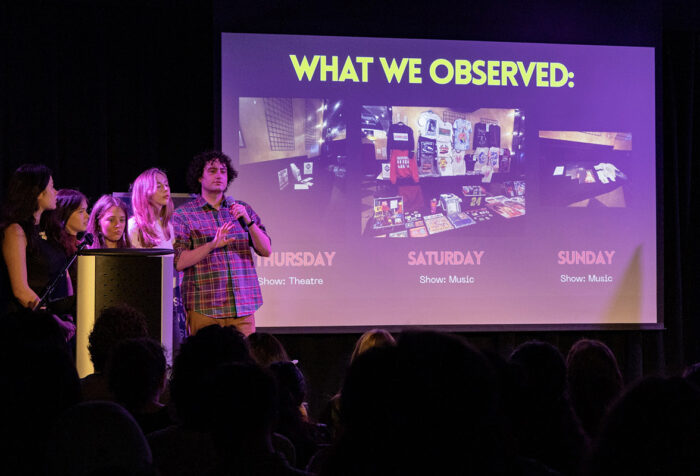 Four people on stage present their projects