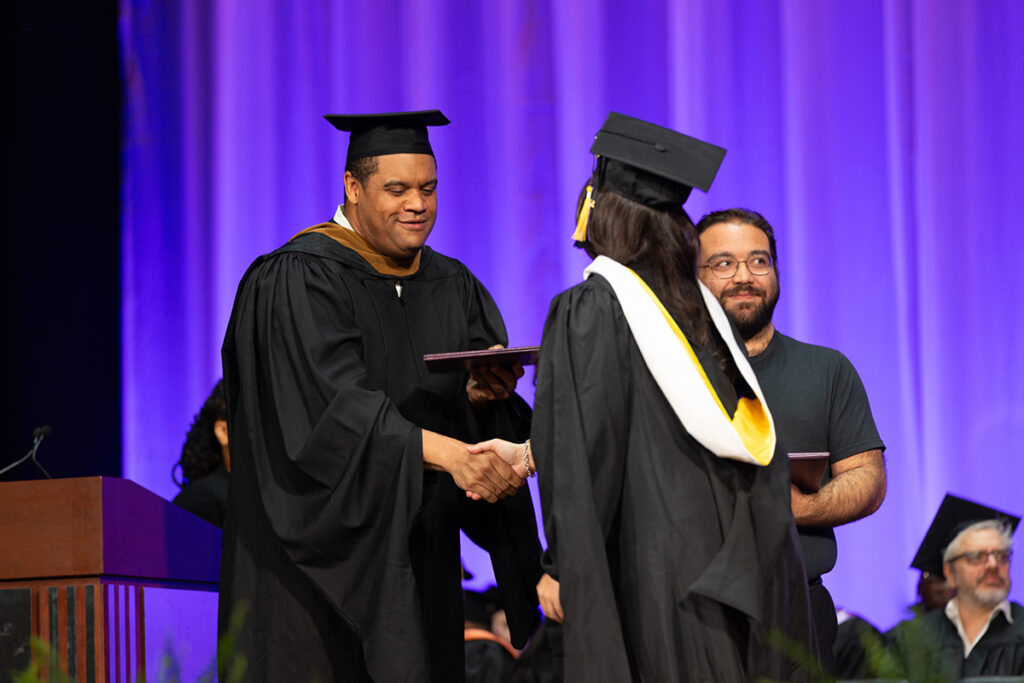 SOF Dean shakes hands of graduate