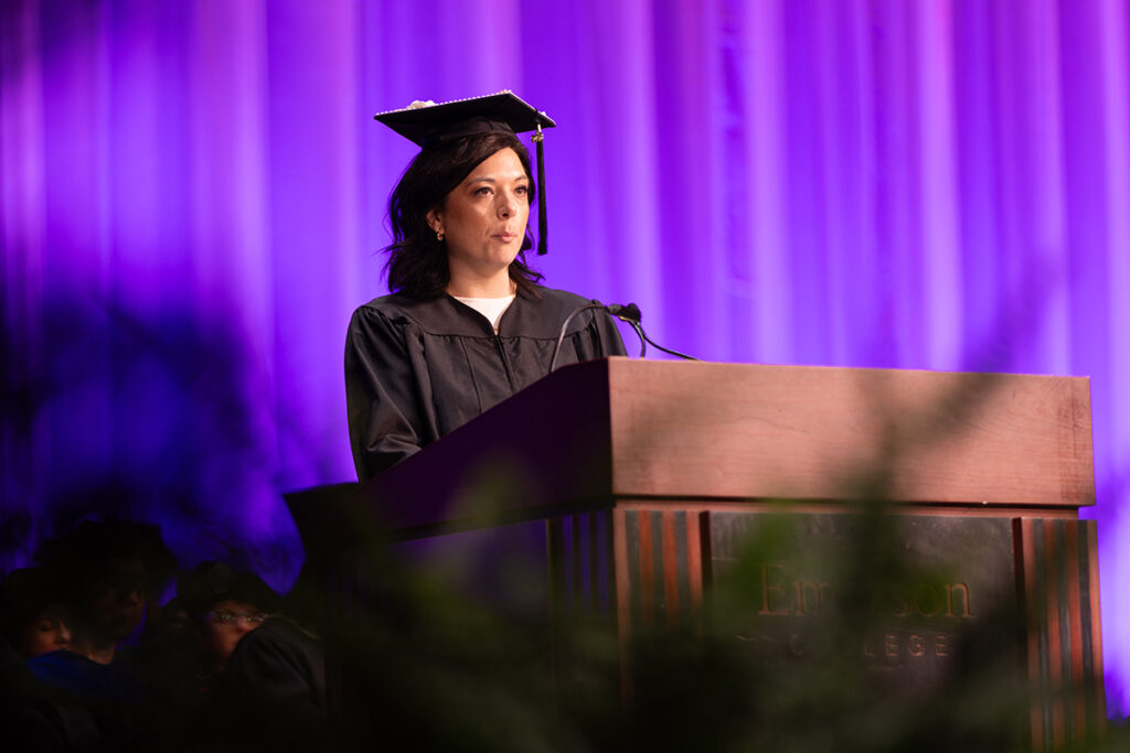 Katie Desmarais speaks at podium in cap and gown