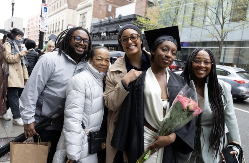 A graduate with their family pose for a photo