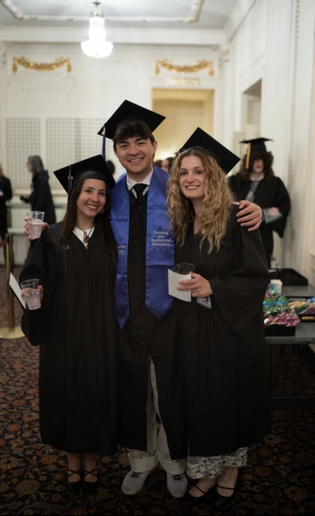 Three people pose for a photo