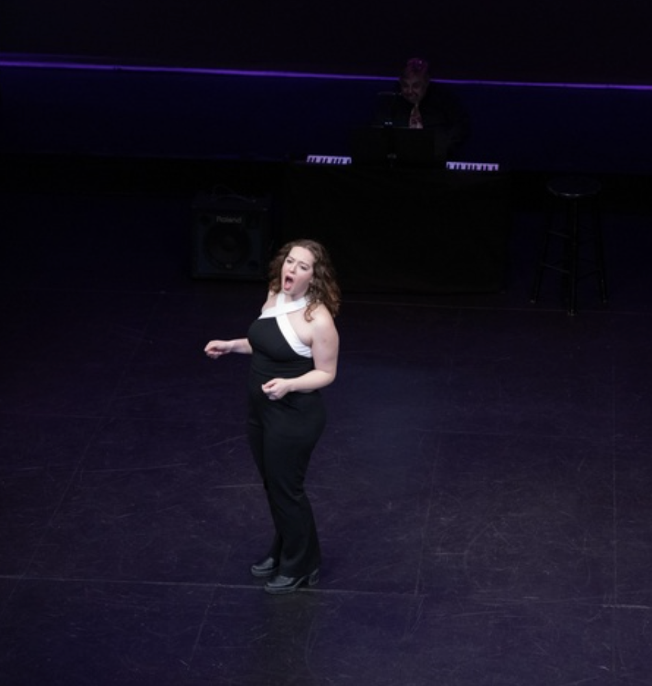 A woman sings on stage