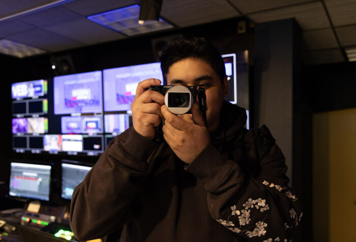 Marcos Quinones holds a camera to his face