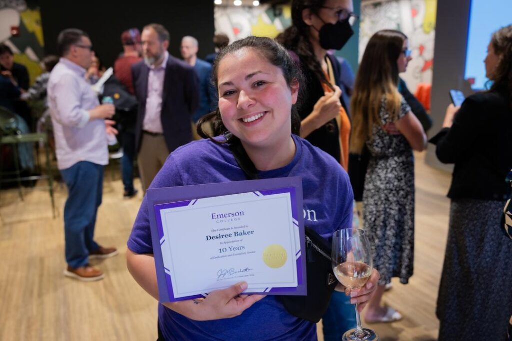 Desiree Baker holds up her certificate
