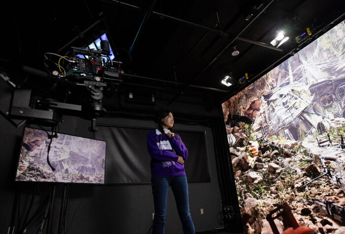 woman looks at images on huge screen