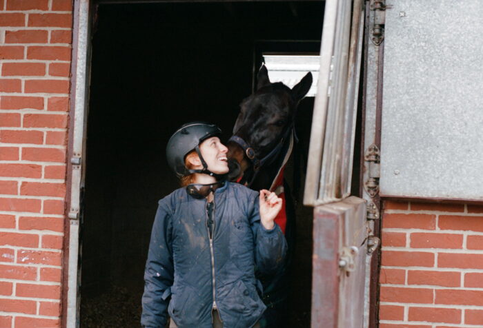 Zoey Schorsch standing outside next to her horse