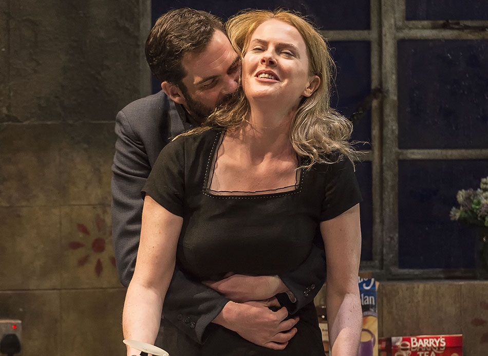 Marty Rea kisses Aisling O'sullivan from behind in a scene from Beauty Queen of Leenane