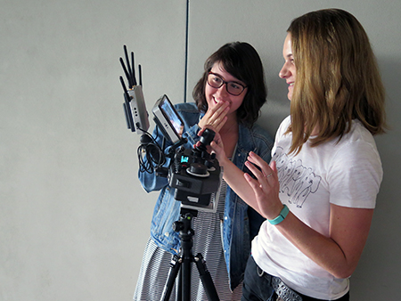 Nicole Eng ’17, left, watches Madeline Taylor ’16 operate a drone camera. Photo/Daryl Paranada