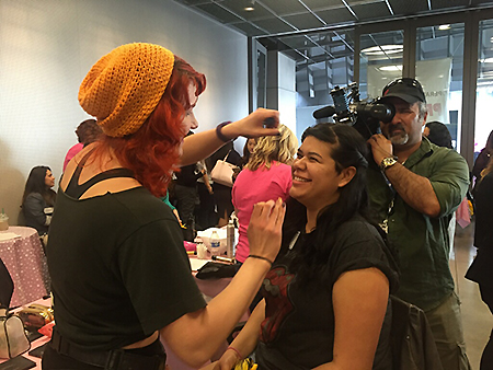 High school senior Sally Hernandez receives makeup tips from a volunteer.