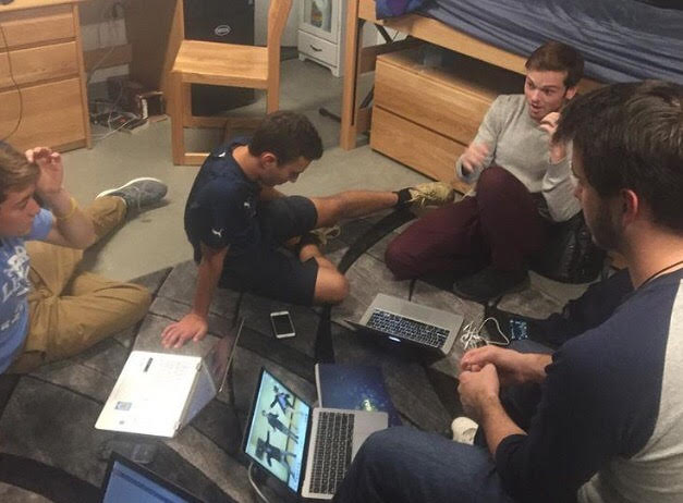 Students sitting on the floor with laptops